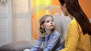 Mother and daughter talking, mom explaining how to behave in life situations photo