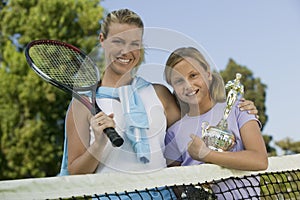 Mother and Daughter at Tennis Net with Trophy