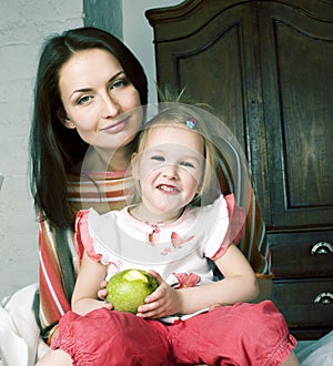 Mother with daughter together in bed smiling, happy family close up, lifestyle people concept, cool real modern family