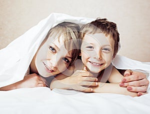 Mother with daughter together in bed smiling, happy family close up, lifestyle people concept, cool real modern family