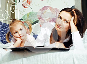 Mother with daughter together in bed smiling, happy family close up, lifestyle people concept, cool real modern family