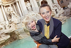 Mother and daughter tourists at Trevi Fountain having fun time
