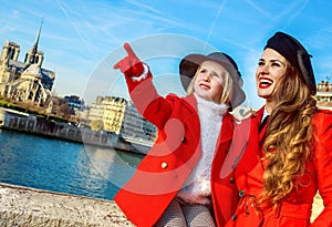 Mother and daughter travellers in Paris pointing at something