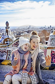 Mother and daughter travellers taking selfie at Guell Park