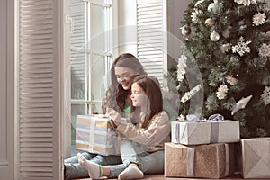 Mother and daughter unpack christmas gift
