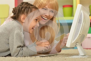 Mother and daughter using computer