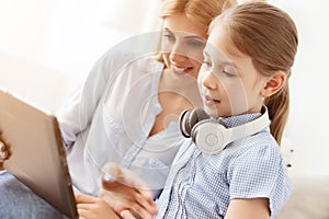 Mother and daughter using digital tablet