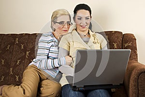 Mother and daughter using laptop