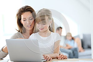 Mother and daughter using laptop