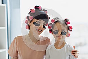 Mother and daughter using patches while relaxing at home.