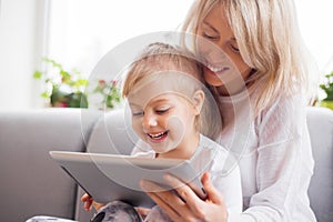 Mother and daughter using tablet computer together