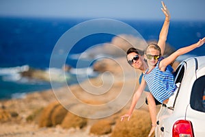 Mother and daughter on vacation travel by car. Summer holiday and car travel concept. Family travel.