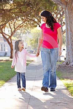 Mother And Daughter Walking Along Path