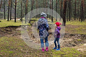 Mother and daughter walking in forest