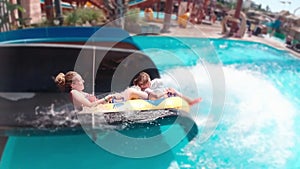 Mother And Daughter On A Water Slide