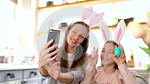 Mother and daughter wearing bunny ears doing selfie