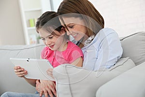 Mother and daughter websurfing on a tablet photo