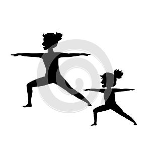 Mother and daughter, woman and girl child doing yoga exercises, standing in warrior two position