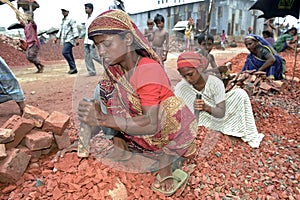 Mother and daughter working as stone breakers