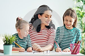 Mother and daughters drawing together