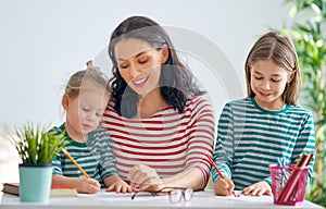 Mother and daughters drawing together