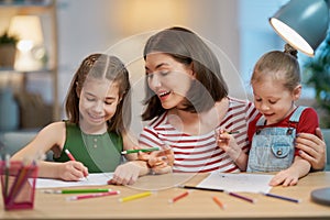 Mother and daughters drawing together