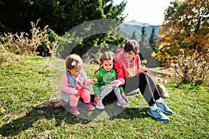 Mother with daughters enjoying in the mountains.The concept of family travel, adventure, and tourism. Lifestyle and hiking autumn