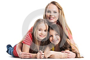 Mother and daughters lying on the floor