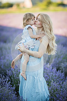 Mother and dauther in lavender field in blu dress