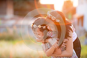 Mother day and family concept - Happy smiling daughter and  her mother hugging with beautiful light flare