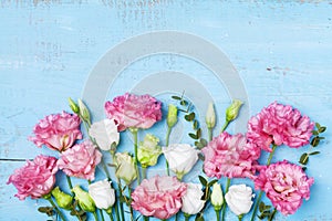 Mother day greeting card. Beautiful spring flowers on blue wooden table top view. Flat lay