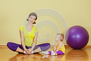 Mother do phisical exercises with her daughter