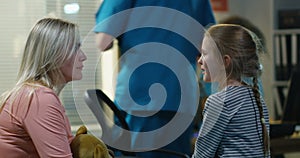 Mother and doctor encouraging girl in a hospital