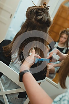 Mother doing haircut to her daughter.