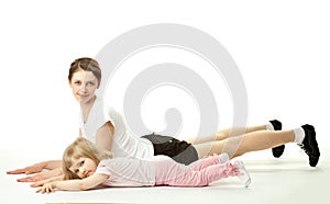 Mother doing sport exercises with her daughter