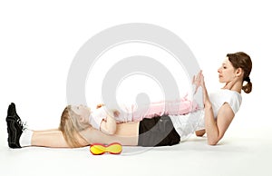 Mother doing sport exercises with her daughter