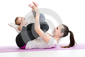 Mother doing yoga exercise with baby