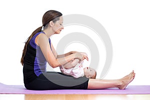 Mother doing yoga exercise with her baby