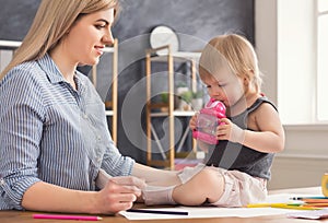 Mother drawing with her daughter