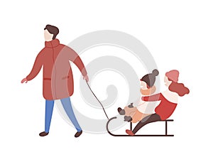 Mother drawing sled with her children. Parent and kids having fun outdoors together. Winter leisure activity. Cute