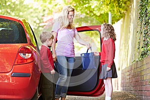 Mother Driving To School With Children