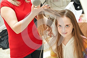 Mother dry daughter hair. Home activity. New normal. Barber equipment