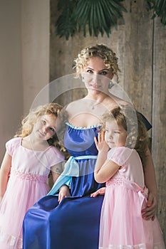 Mother embraces beautiful twin daughters