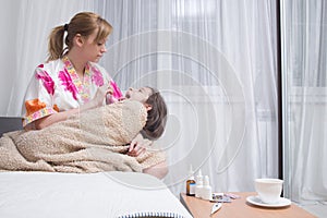 Mother embraces the sick child. sore throat, flu