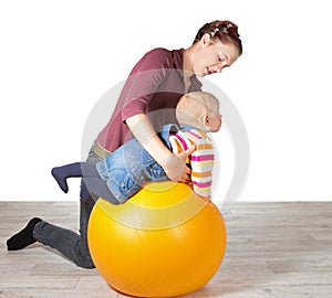 Mother exercising her young baby