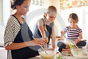 Mother, family or kids baking in kitchen with siblings learning cookies recipe or mixing pastry at home. Girl, mom
