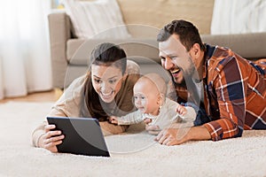 Mother, father and baby with tablet pc at home