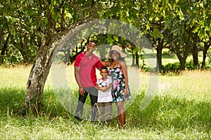 Mother Father And Child Smiling At Camera With Football