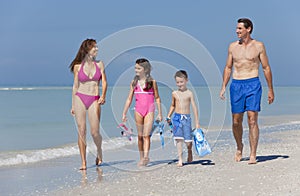 Mother, Father & Children Family Walking on Beach