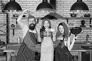 Mother and father cooking with daughter. happy family day. friendly family in kitchen. healthy food at home. kid chef